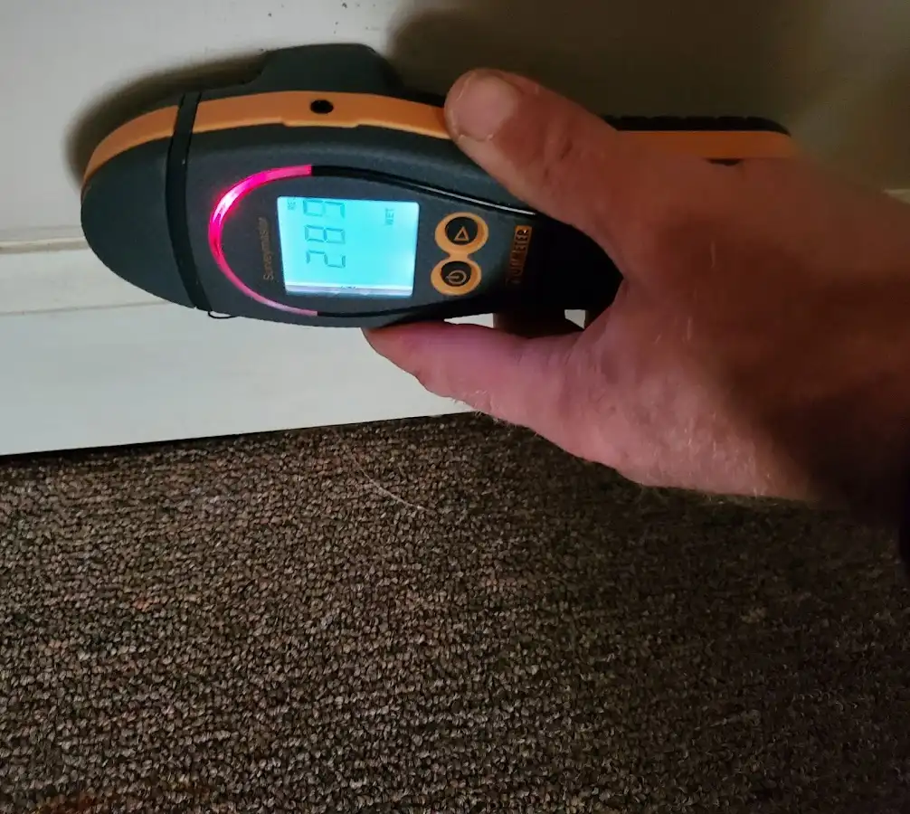 Moisture detection at baseboard during Storm Damage Restoration in Summit Park